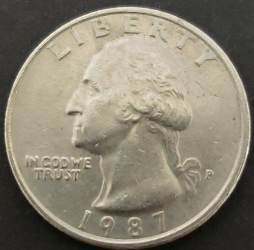 1987-P Washington Quarter clipped planchet error showing a curved section missing from the coin's rim, caused by punch overlap during blank preparation